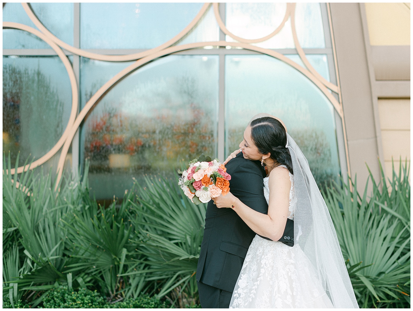 Bride and groom embrace outside Disney's Riviera Resort during their first look on their wedding day. By Elizabeth Kane Photography in Orlando Florida
