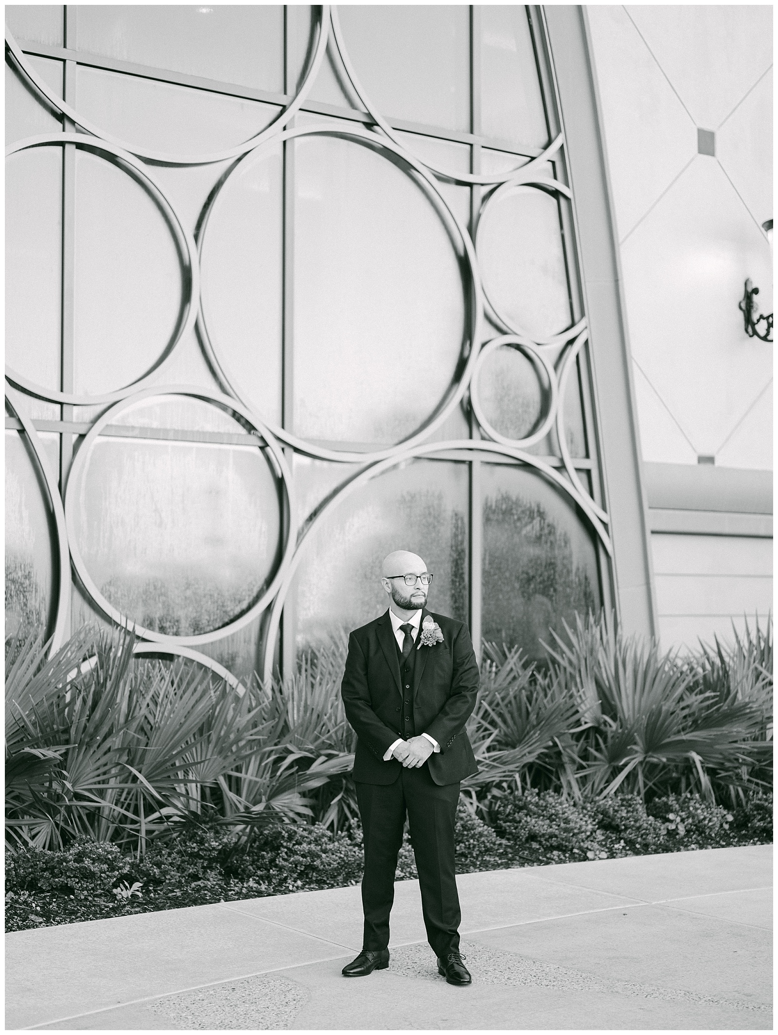 Black and white groom portrait at courtyard outside Disney's Riviera Resort before first look. By Elizabeth Kane Photography in Orlando Florida