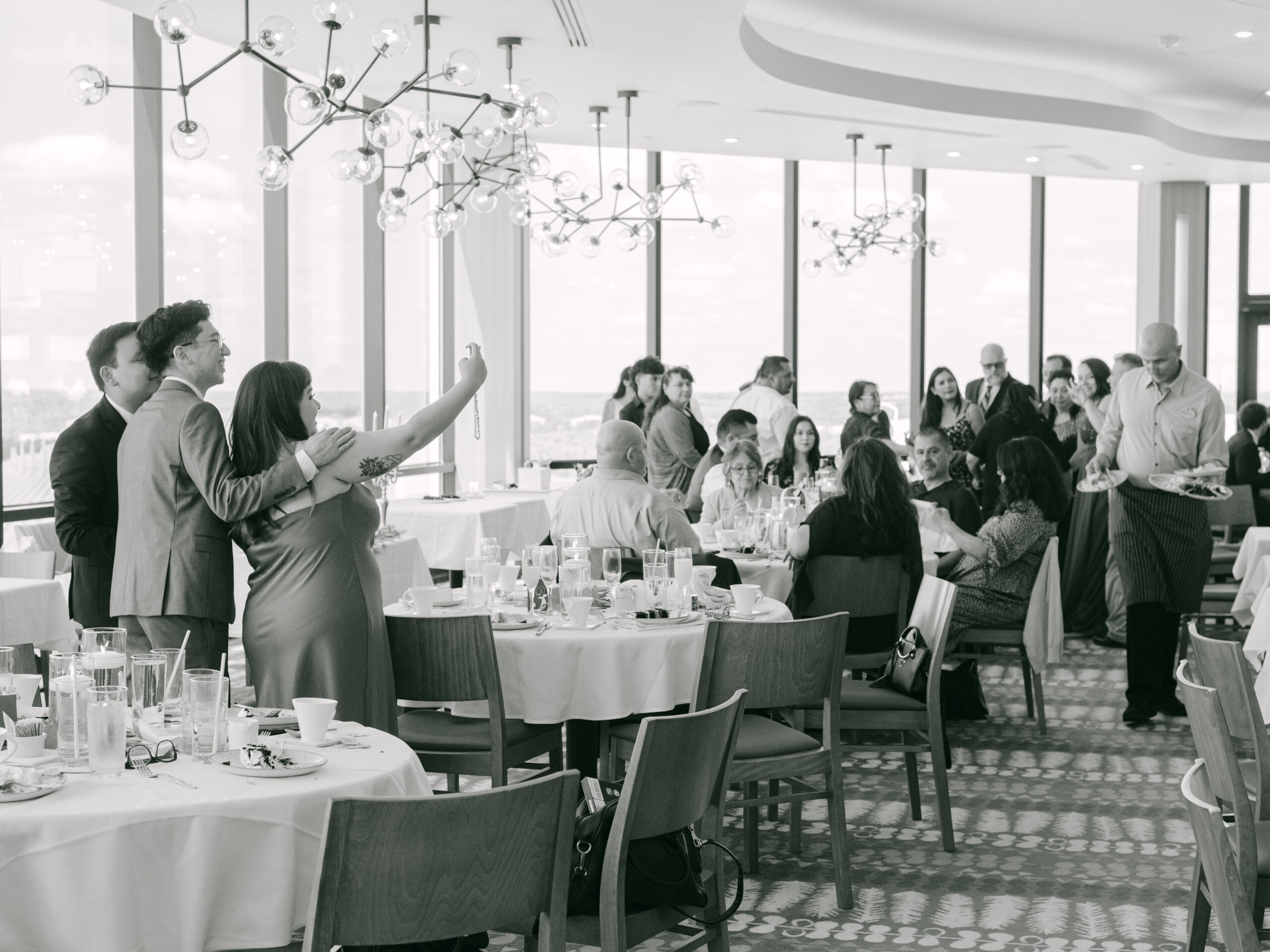 Guests captured in a candid moment while dining at the wedding reception by Elizabeth Kane Photography Orlando Florida Disney Destination Wedding Photographer