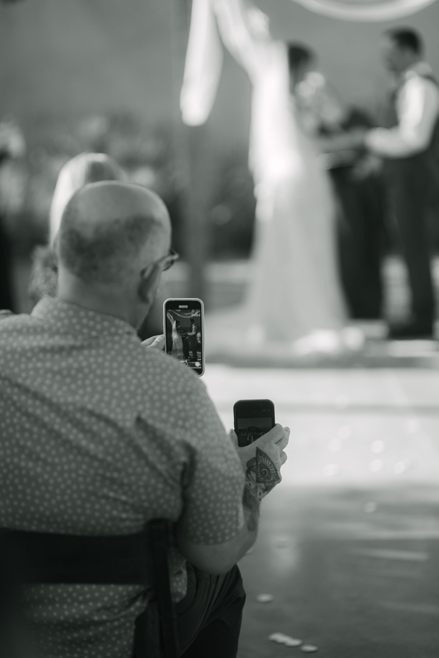 Guests capturing candid moments on their phones during the wedding by Elizabeth Kane Photography California Destination Wedding Photographer