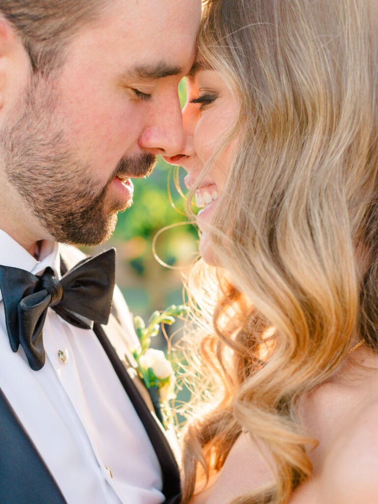 Emotional close-up of bride and groom sharing an intimate moment at their Bougainvillea Estate wedding in Indio, CA, captured in golden hour light.