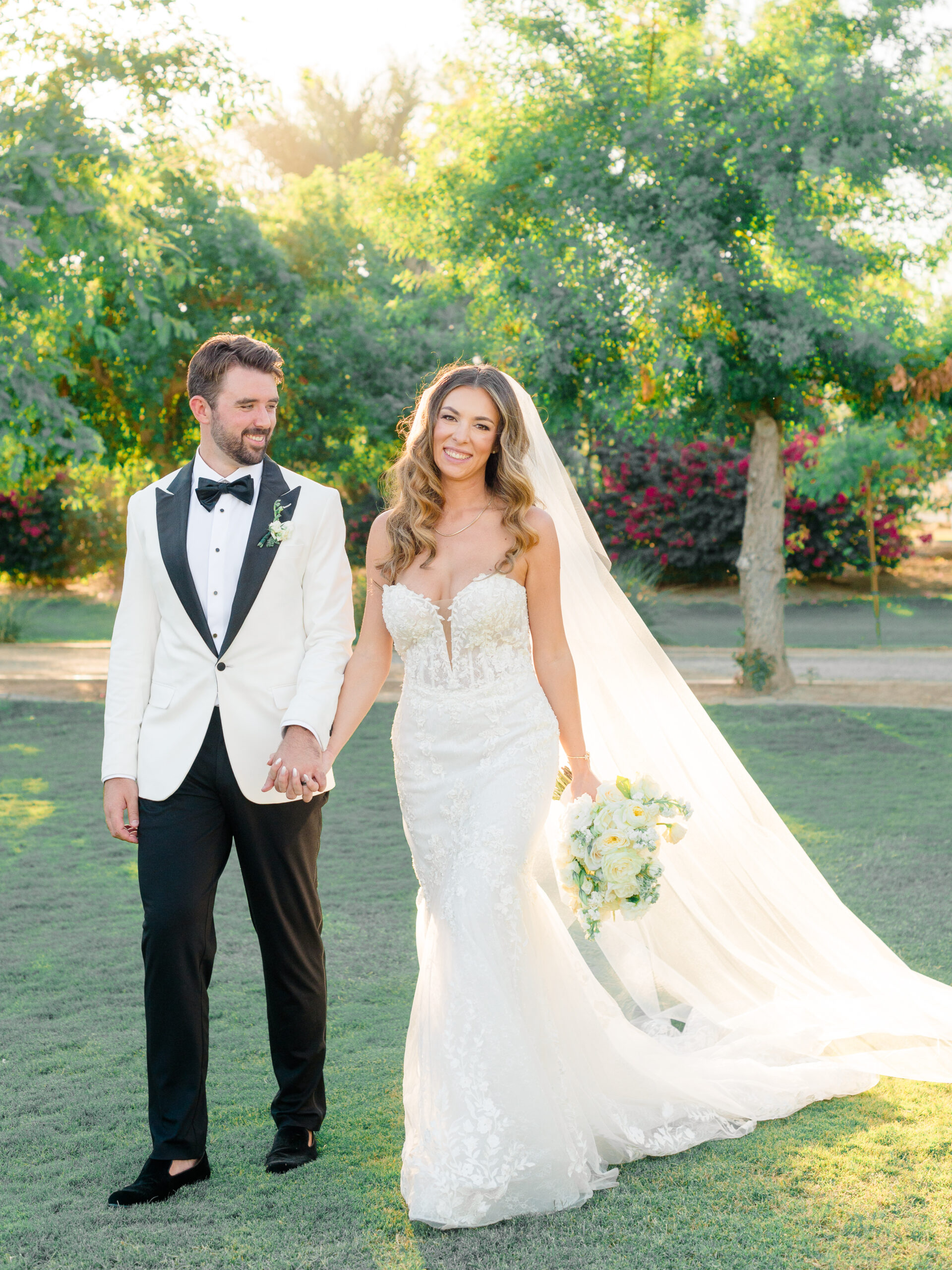 Bride and groom walk hand-in-hand at golden hour during a fine art celebration, captured as part of a Philadelphia wedding photography galleries by Elizabeth Kane.