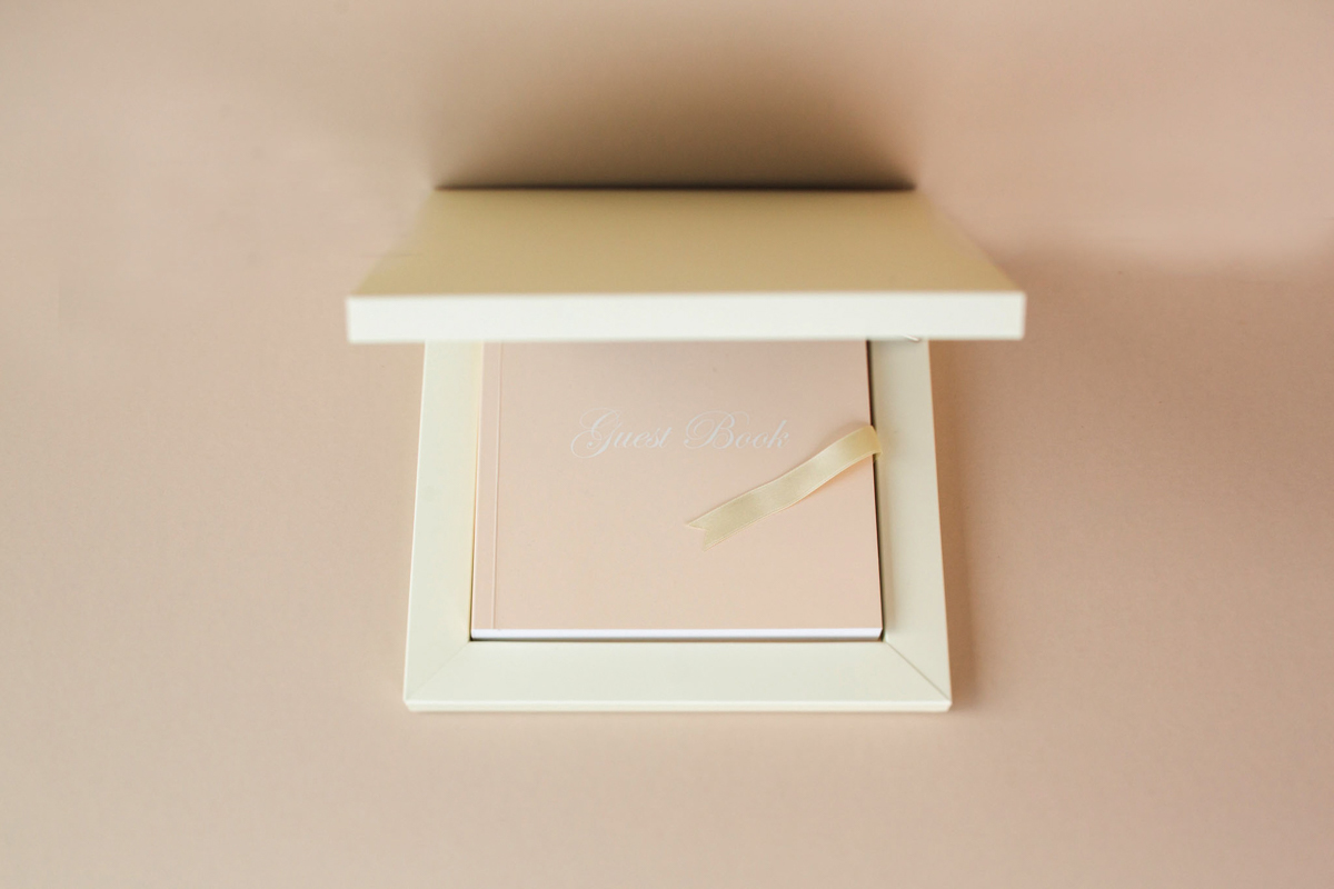 Elegant wedding guest book with ribbon detail, a reminder of the hidden costs of wedding photography when capturing meaningful keepsakes and heirloom details.