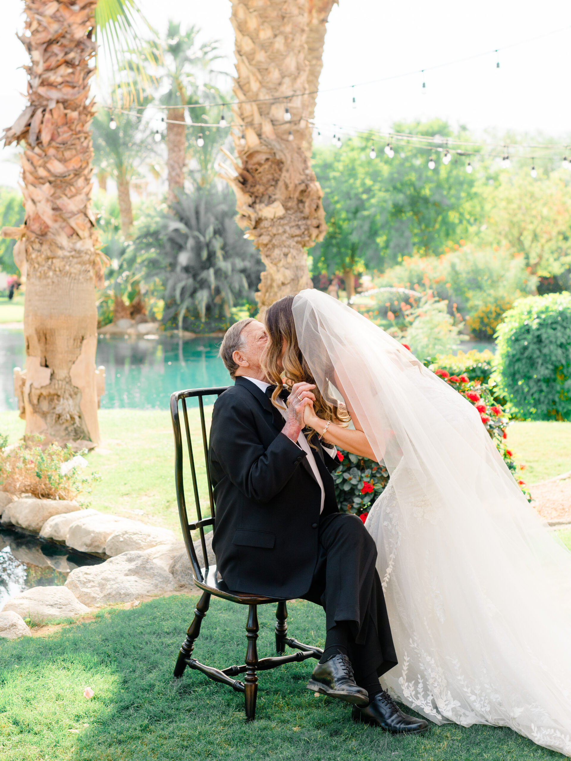 Emotional portrait of bride sharing a kiss with her grandfather at an elegant estate wedding, photographed by a Philadelphia wedding photographer.