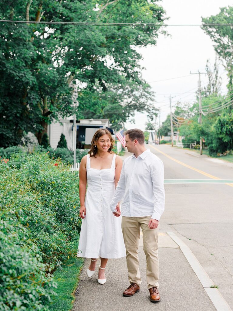 couple waking on the street modeling Philadelphia Engagement Photo Outfits