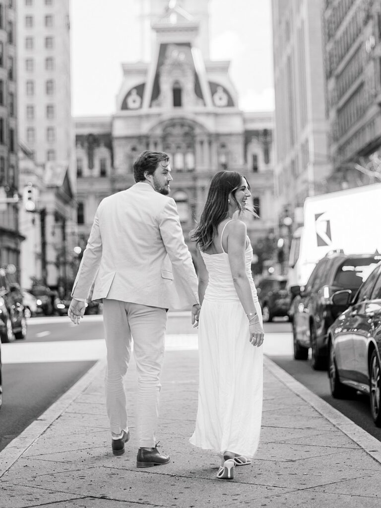 couple walking through the city modeling Philadelphia Engagement Photo Outfits